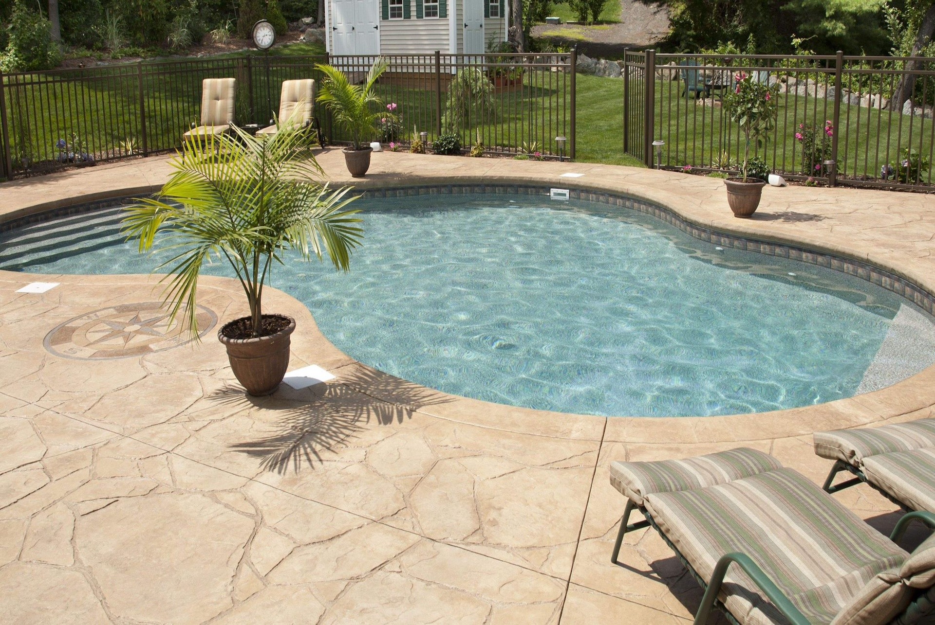 Light-colored, non-slip stamped concrete around swimming pools in Maspalomas, Canary Islands